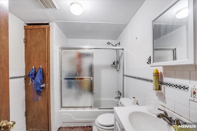 full bathroom with toilet, enclosed tub / shower combo, backsplash, tile walls, and vanity