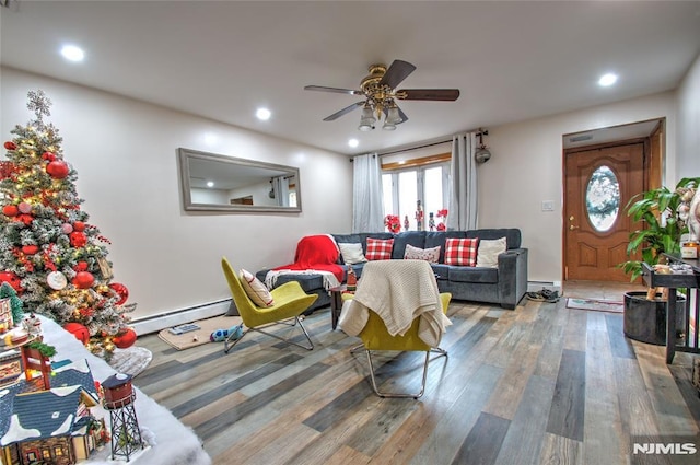 living room featuring ceiling fan, a baseboard radiator, and hardwood / wood-style flooring