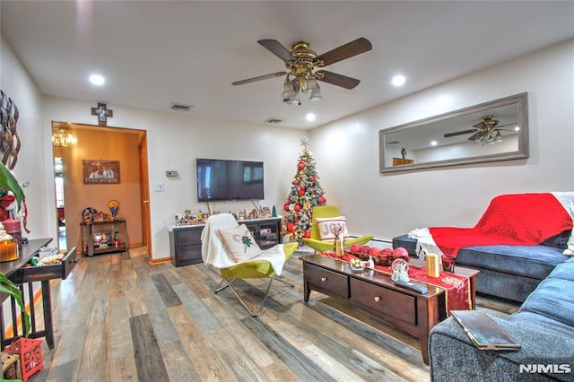 living room featuring ceiling fan and hardwood / wood-style flooring