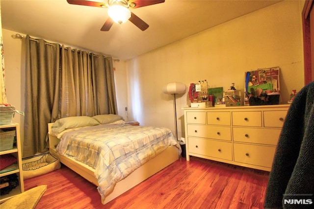 bedroom featuring wood-type flooring and ceiling fan