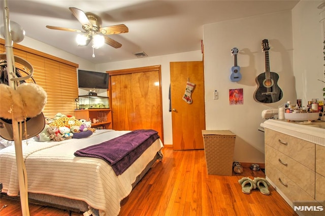 bedroom with ceiling fan and light hardwood / wood-style flooring