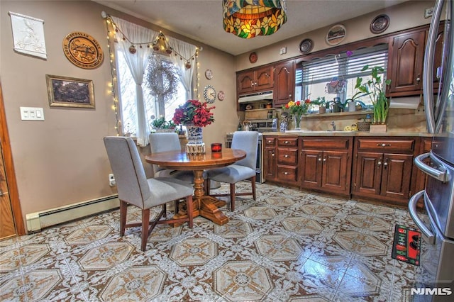 dining area featuring a baseboard radiator and sink