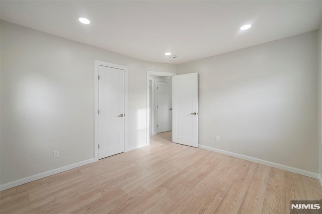 empty room with light hardwood / wood-style floors