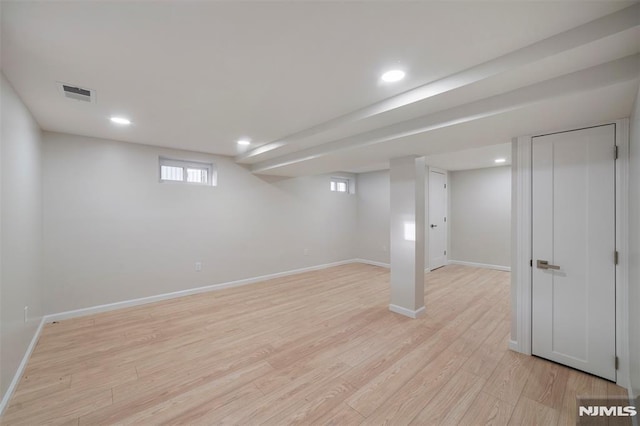 basement with light hardwood / wood-style floors