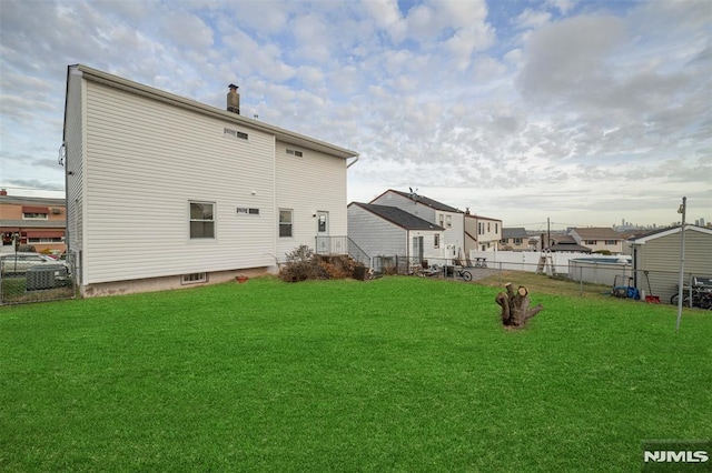 rear view of house featuring a lawn