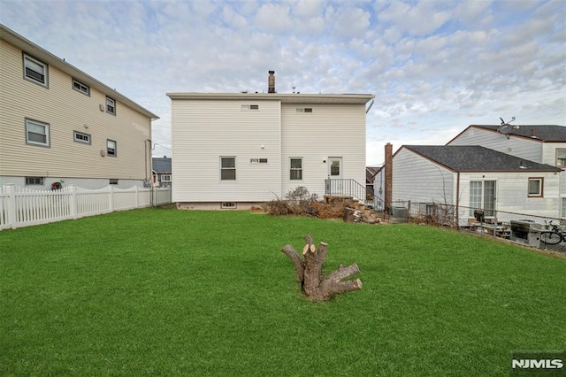 rear view of property with a lawn