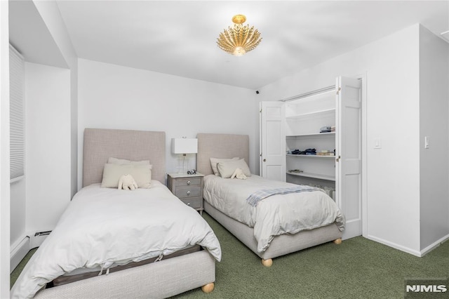 carpeted bedroom featuring a baseboard heating unit