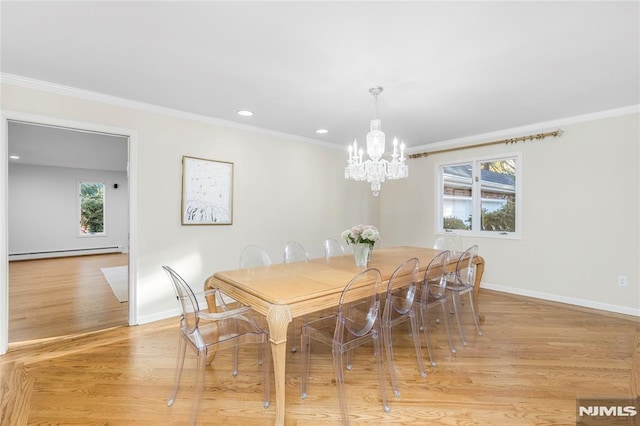 dining room with ornamental molding, a baseboard radiator, light hardwood / wood-style floors, and a wealth of natural light