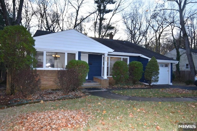 ranch-style home with a front lawn and a garage