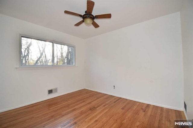 spare room with ceiling fan and light hardwood / wood-style floors