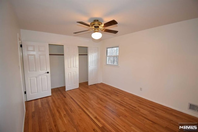 unfurnished bedroom with hardwood / wood-style flooring and ceiling fan