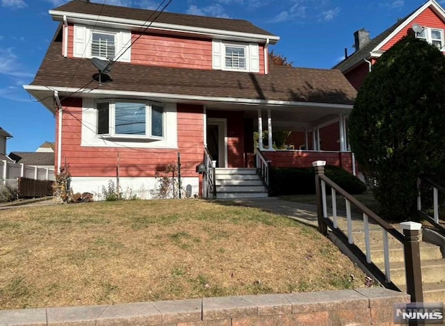 view of front of house featuring covered porch and a front lawn