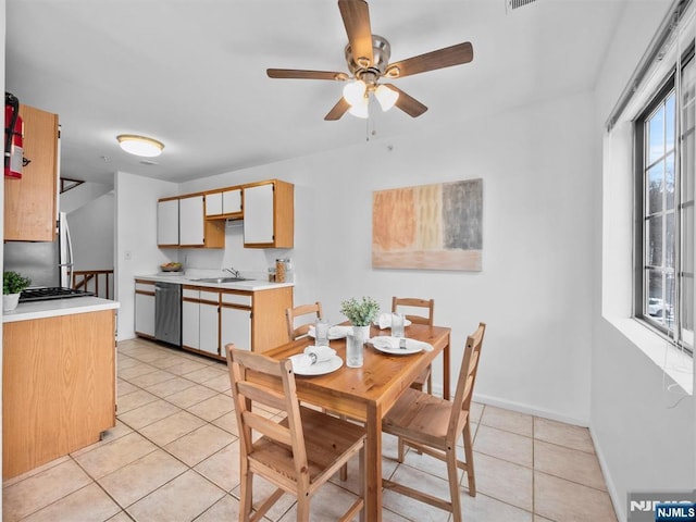 tiled dining area with sink and ceiling fan