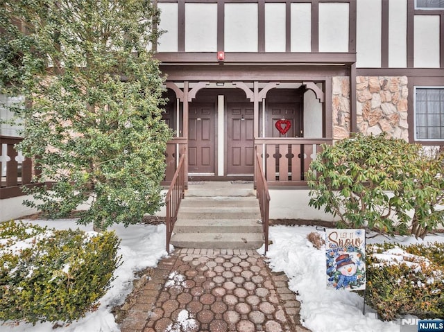 view of snow covered property entrance