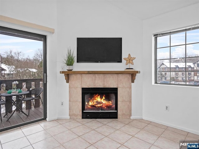 unfurnished living room with a fireplace and tile patterned floors