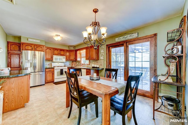 dining room with a notable chandelier and sink