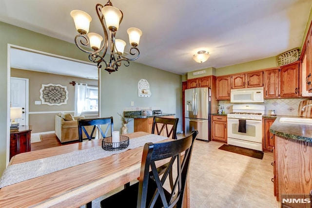 dining room with an inviting chandelier and sink