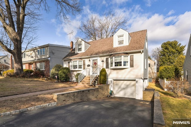 cape cod-style house with a garage