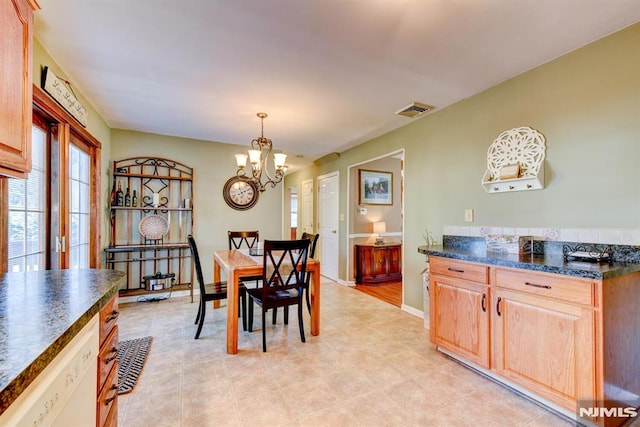 dining space with an inviting chandelier and light tile patterned flooring