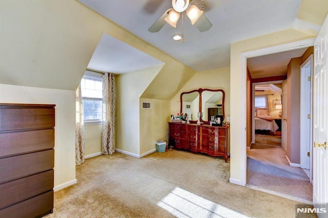 additional living space featuring ceiling fan, light carpet, and vaulted ceiling