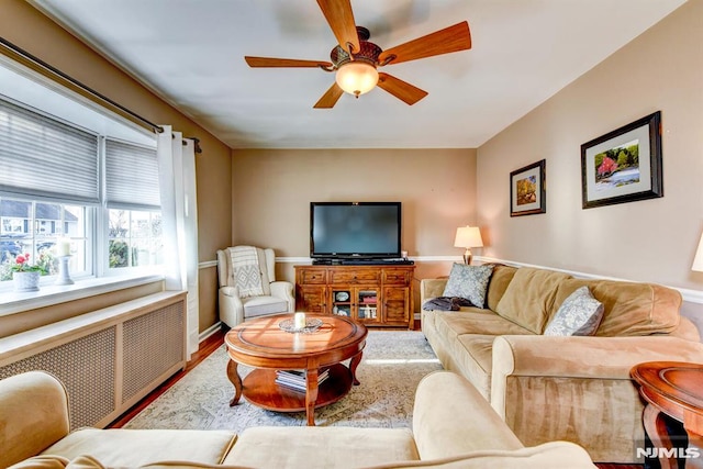 living room featuring radiator, hardwood / wood-style floors, and ceiling fan