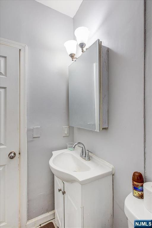 bathroom with toilet and vanity