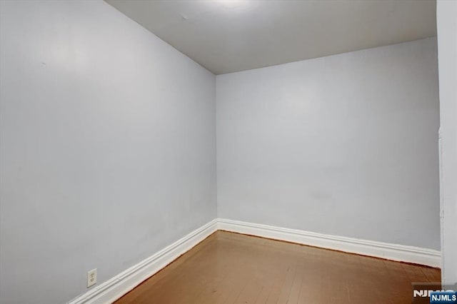 empty room with hardwood / wood-style floors