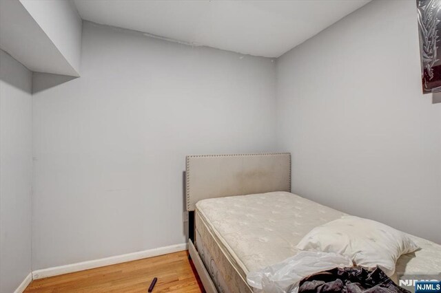 bedroom with hardwood / wood-style flooring