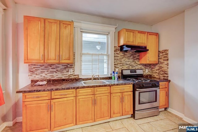 kitchen featuring light tile patterned flooring, sink, tasteful backsplash, and stainless steel gas range oven