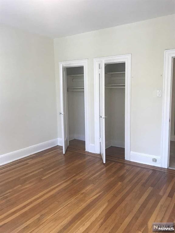 unfurnished bedroom featuring dark wood-type flooring