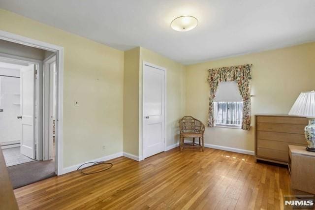 unfurnished bedroom with wood-type flooring