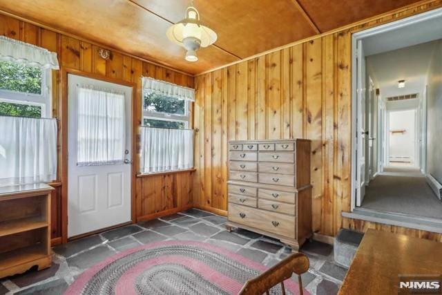 entryway featuring wood walls