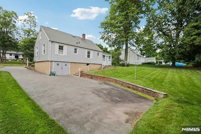 view of side of home featuring a yard