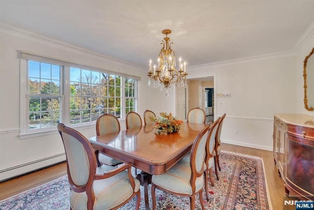 dining space with a baseboard radiator, an inviting chandelier, light wood-style flooring, and crown molding