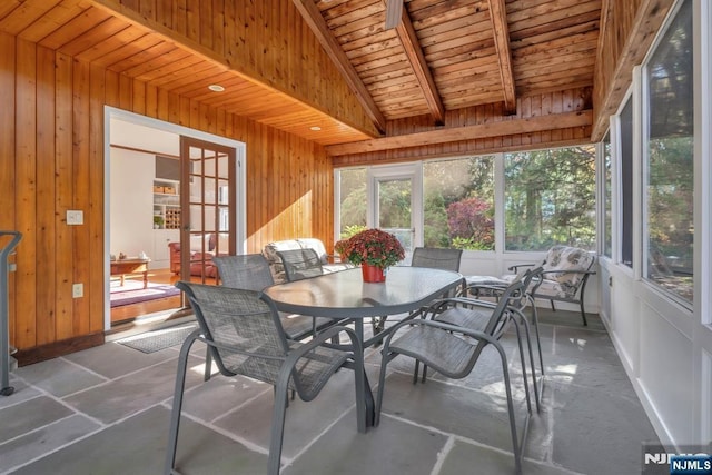 sunroom featuring wooden ceiling, beamed ceiling, and french doors