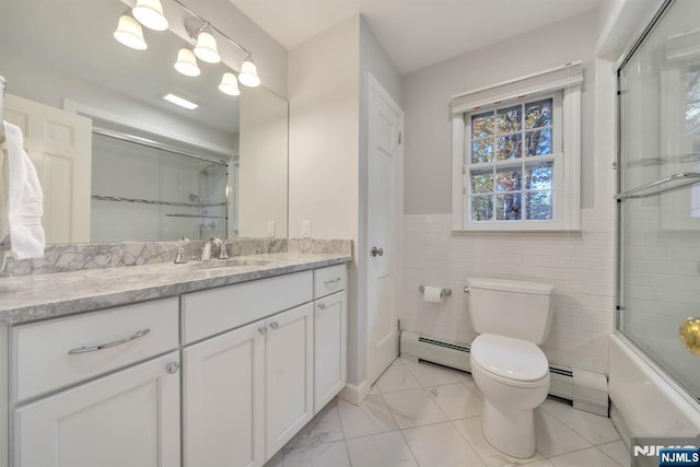 full bathroom with toilet, marble finish floor, tile walls, a baseboard radiator, and vanity