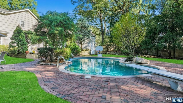 view of pool featuring a fenced in pool, a diving board, a patio, and fence