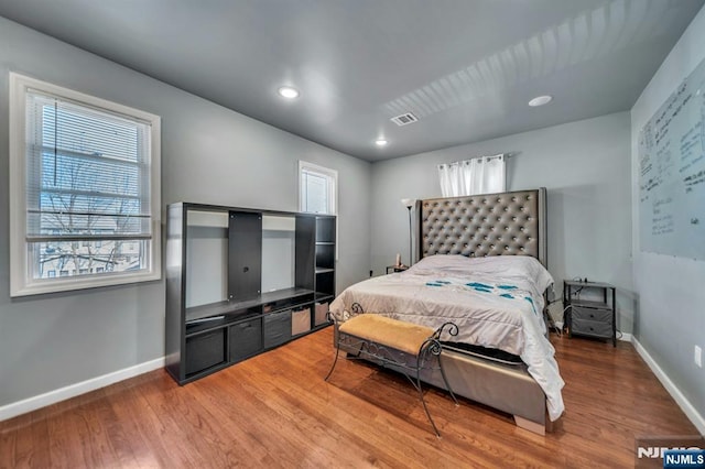 bedroom with hardwood / wood-style flooring