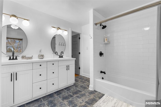 bathroom with vanity and tiled shower / bath