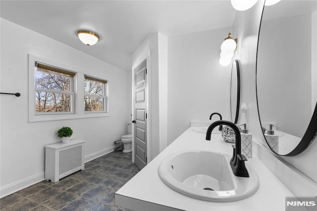 bathroom featuring radiator, vanity, and toilet