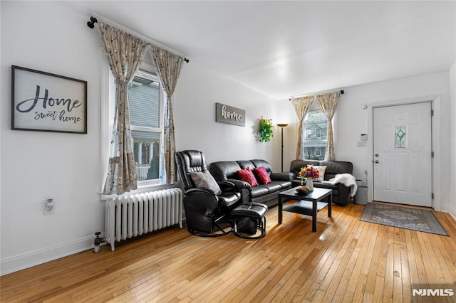 living room with radiator and hardwood / wood-style flooring