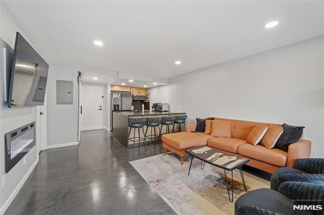 living room featuring electric panel, sink, and heating unit