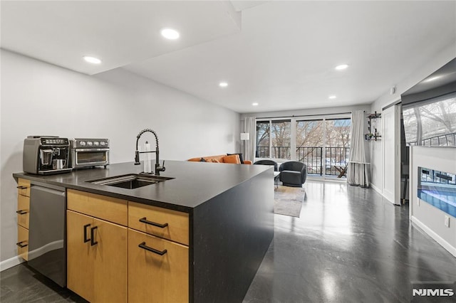 kitchen featuring sink, dishwasher, and a center island with sink