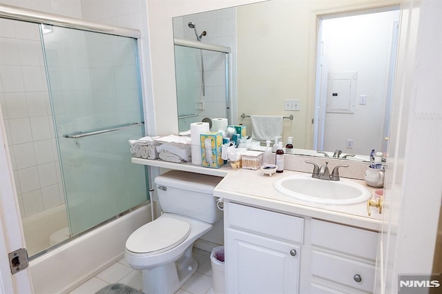 full bathroom featuring combined bath / shower with glass door, vanity, tile patterned floors, and toilet