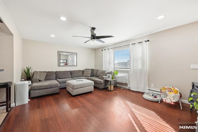 living room with ceiling fan and dark hardwood / wood-style floors