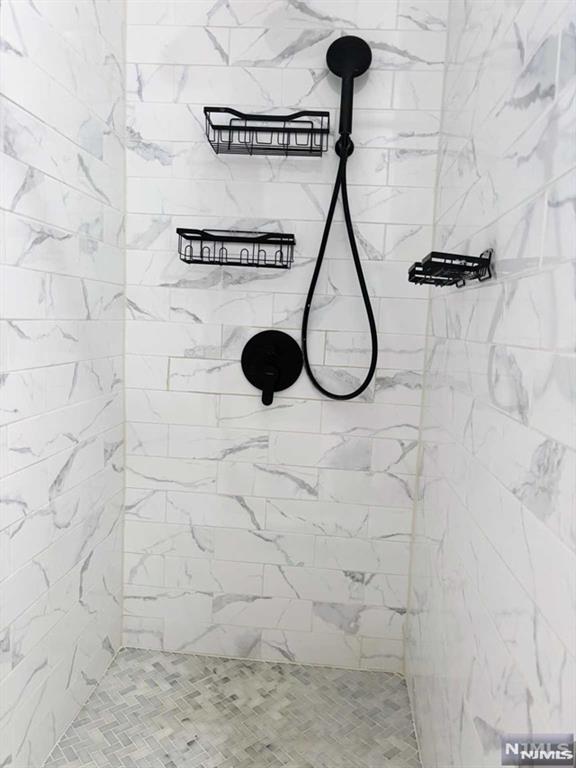 bathroom with a tile shower