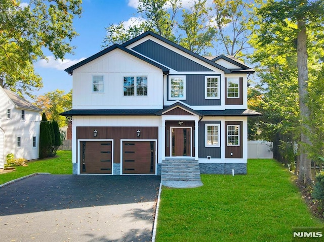 view of front of home with a front yard and a garage