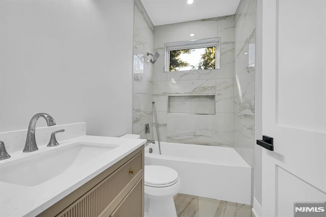 full bathroom featuring toilet, vanity, and tiled shower / bath combo