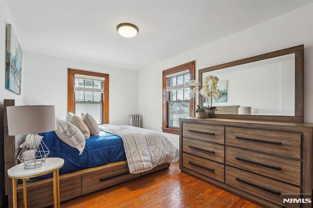 bedroom with radiator and wood-type flooring