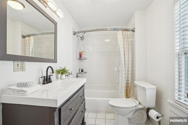 full bathroom with toilet, vanity, tile patterned floors, and plenty of natural light